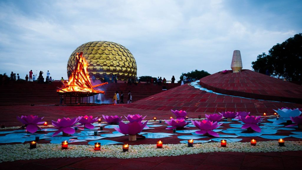 The golden dome of Matrimandir amidst lush greenery and peaceful meditation spaces.