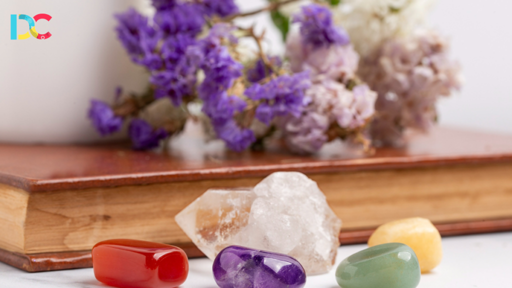 Healing crystals flat lay featuring rose quartz, amethyst, and sage for positive energy