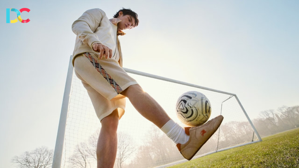 Footballer walking in a luxury streetwear outfit before a match